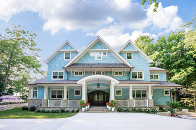 Large traditional blue four-story shingle exterior home idea in Other with a shingle roof and a gray roof