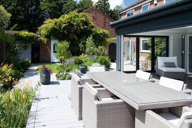 Photo of a small coastal back patio in Kent with decking and no cover.