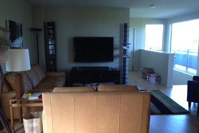 Inspiration for a timeless light wood floor living room remodel in San Francisco with beige walls and a wall-mounted tv