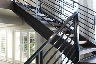 Example of a trendy wooden metal railing staircase design in Salt Lake City