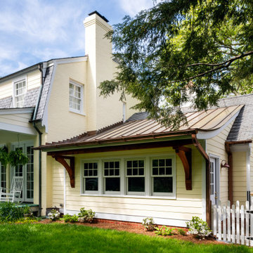 Addition with curved copper roof and generously sized wood brackets.