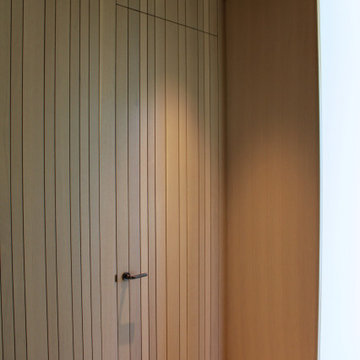 Seamless Wood Paneling with Concealed Closet Door