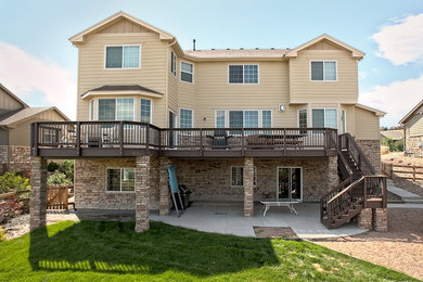 Example of a large arts and crafts backyard patio design in Denver with decking and no cover