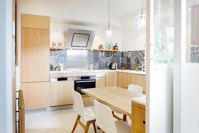 This is an example of a mid-sized l-shaped separate kitchen in Dijon with no island.