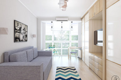 Источник вдохновения для домашнего уюта: маленькая изолированная гостиная комната в современном стиле с серыми стенами, полом из ламината, телевизором на стене и бежевым полом для на участке и в саду
