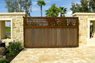 This is an example of a large mediterranean front yard driveway in Los Angeles.