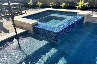 Example of a transitional backyard concrete and rectangular pool design in Houston