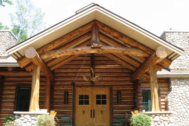 Inspiration for a large timeless brown two-story mixed siding exterior home remodel in Other
