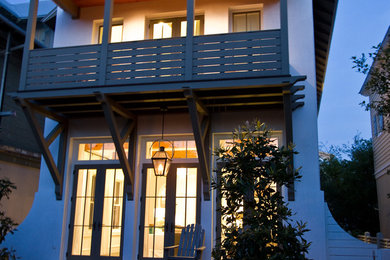 Inspiration for a mid-sized coastal white two-story stucco gable roof remodel in Miami