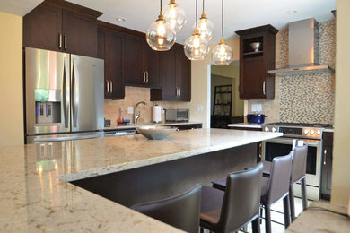 Inspiration for a large transitional u-shaped kitchen remodel in DC Metro with an undermount sink, shaker cabinets, dark wood cabinets, quartz countertops, multicolored backsplash, mosaic tile backsplash, stainless steel appliances and an island