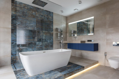 Example of a mid-sized minimalist master beige tile and porcelain tile porcelain tile, beige floor and single-sink bathroom design in Houston with flat-panel cabinets, blue cabinets, a wall-mount toilet, an undermount sink, quartz countertops, gray countertops and a floating vanity