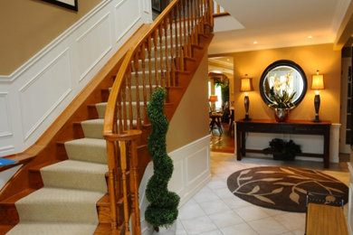 Transitional wood staircase in Toronto with wood risers.