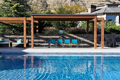 Pool - large contemporary backyard concrete paver and rectangular lap pool idea in Salt Lake City