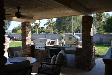 Inspiration for a traditional backyard partial sun garden for summer in Phoenix with concrete pavers.