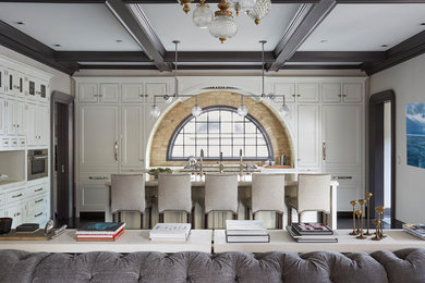 Example of a large classic dark wood floor and brown floor open concept kitchen design in Chicago with a farmhouse sink, flat-panel cabinets, white cabinets, quartzite countertops, yellow backsplash, brick backsplash, white appliances and an island