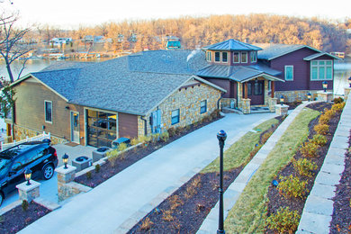 Large contemporary multicolored two-story mixed siding exterior home idea in Other with a shingle roof