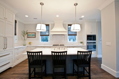 Kitchen - large transitional u-shaped dark wood floor kitchen idea in Charleston with a single-bowl sink, white cabinets, marble countertops, white backsplash and paneled appliances