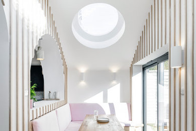 Design ideas for a medium sized contemporary open plan dining room in London with medium hardwood flooring, brown floors and multi-coloured walls.