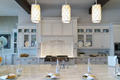 Eat-in kitchen - large transitional galley dark wood floor eat-in kitchen idea in Tampa with a farmhouse sink, recessed-panel cabinets, white cabinets, marble countertops, white backsplash, glass tile backsplash, paneled appliances and an island
