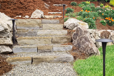 This is an example of a large transitional rock backyard stone and stone fence landscaping in San Francisco.