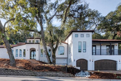Inspiration for a huge mediterranean white one-story stucco gable roof remodel in San Francisco