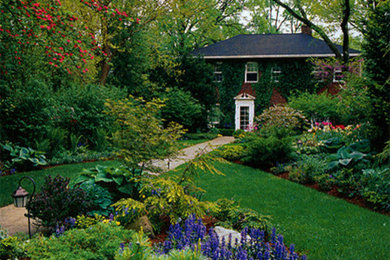 Example of a mid-sized classic red two-story brick exterior home design in Chicago