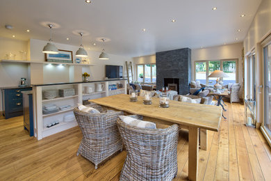 Great room - coastal light wood floor great room idea in Other with beige walls