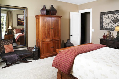 Elegant master carpeted bedroom photo in Other with beige walls