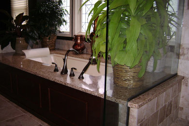 Alcove shower - large master brown tile and porcelain tile porcelain tile alcove shower idea in New York with flat-panel cabinets, dark wood cabinets, an undermount tub, a two-piece toilet, brown walls, a vessel sink and quartz countertops