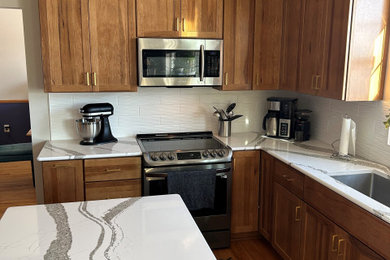 Mid-sized cottage u-shaped eat-in kitchen photo in Other with medium tone wood cabinets, quartz countertops, white backsplash, subway tile backsplash and an island