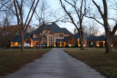 Example of a large classic beige two-story mixed siding exterior home design in Austin