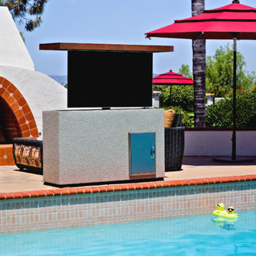Outdoor TV lift island cabinet by pool hides TV and keeps it safe