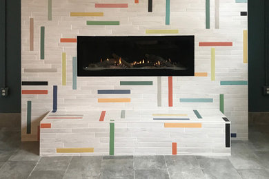 Basement - small modern porcelain tile and gray floor basement idea in Minneapolis with multicolored walls, a standard fireplace and a tile fireplace