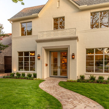 Herringbone brick walkway leading to the French door entry