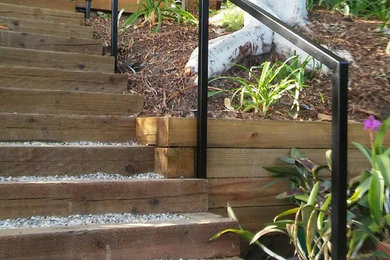 Photo of a mid-sized contemporary drought-tolerant and partial sun backyard gravel garden path in Los Angeles.
