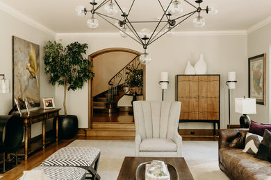 Mid-sized elegant enclosed medium tone wood floor and brown floor living room photo in Portland with white walls, a standard fireplace, a plaster fireplace and no tv