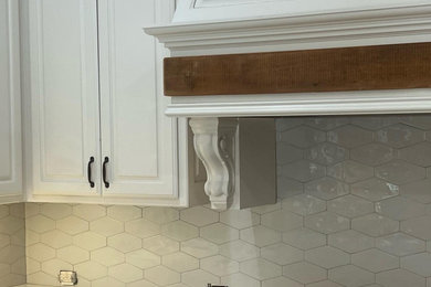 Cottage u-shaped eat-in kitchen photo in Dallas with white cabinets, marble countertops, gray backsplash, ceramic backsplash and an island