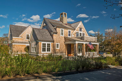 Inspiration for a mid-sized beach style two-storey exterior in Providence with wood siding and a gable roof.