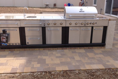Example of a trendy backyard concrete paver patio kitchen design in Los Angeles