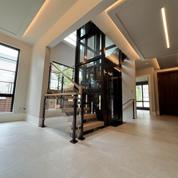 Project #136 | Modern Floating Staircase Encircling Glass Elevator