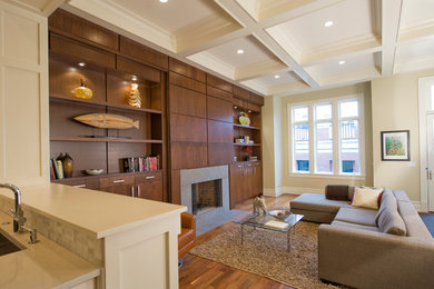 Family room - transitional open concept dark wood floor family room idea in Chicago with beige walls and a standard fireplace