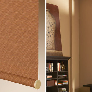 This is an example of a medium sized modern study in Denver with brown walls and a freestanding desk.