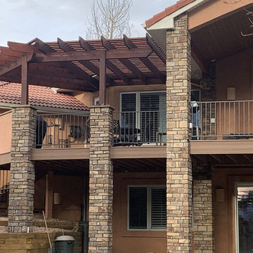 A 364 SF cedar pergola with stucco 1/2 walls and stone columns
