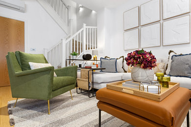 Inspiration for a medium sized modern living room in London with white walls, plywood flooring and no fireplace.