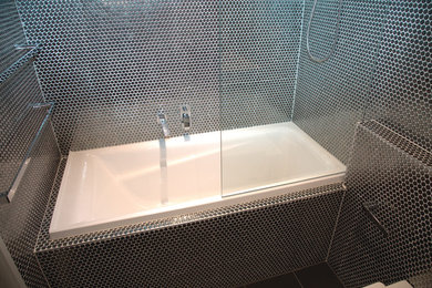 Photo of a small modern bathroom in Brisbane with a drop-in tub.