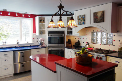 Inspiration for a mid-sized eclectic l-shaped ceramic tile and multicolored floor eat-in kitchen remodel in Portland Maine with shaker cabinets, white cabinets, solid surface countertops, multicolored backsplash, ceramic backsplash, stainless steel appliances, an island and blue countertops