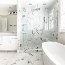 bathroom with strong veining in shower and floor tile