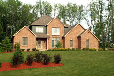 Inspiration for a timeless red two-story brick gable roof remodel in Other