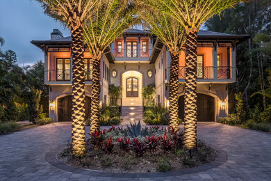 Inspiration for a huge transitional beige two-story stucco exterior home remodel in Other with a hip roof and a tile roof
