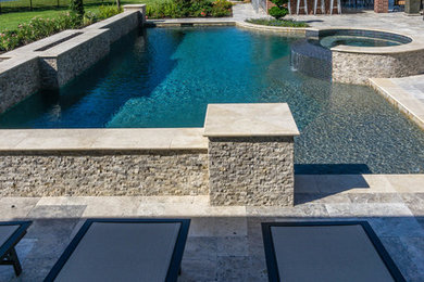 Example of a large minimalist backyard tile and custom-shaped pool fountain design in Houston